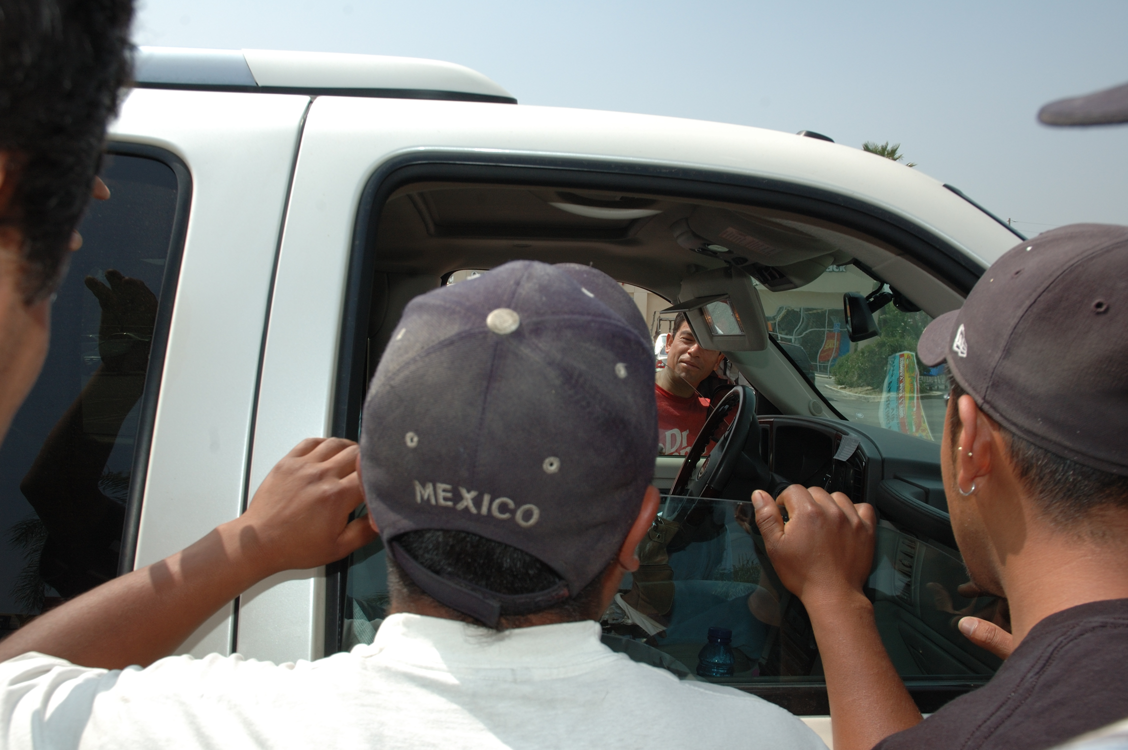 men looking into car